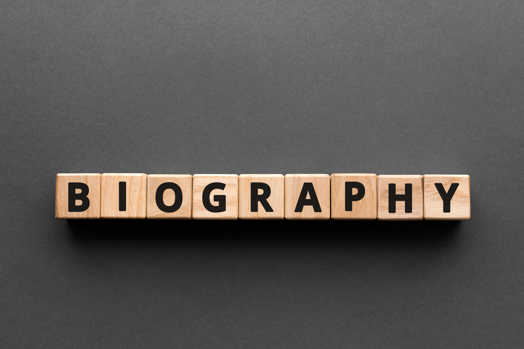 Biography - words from wooden blocks with letters